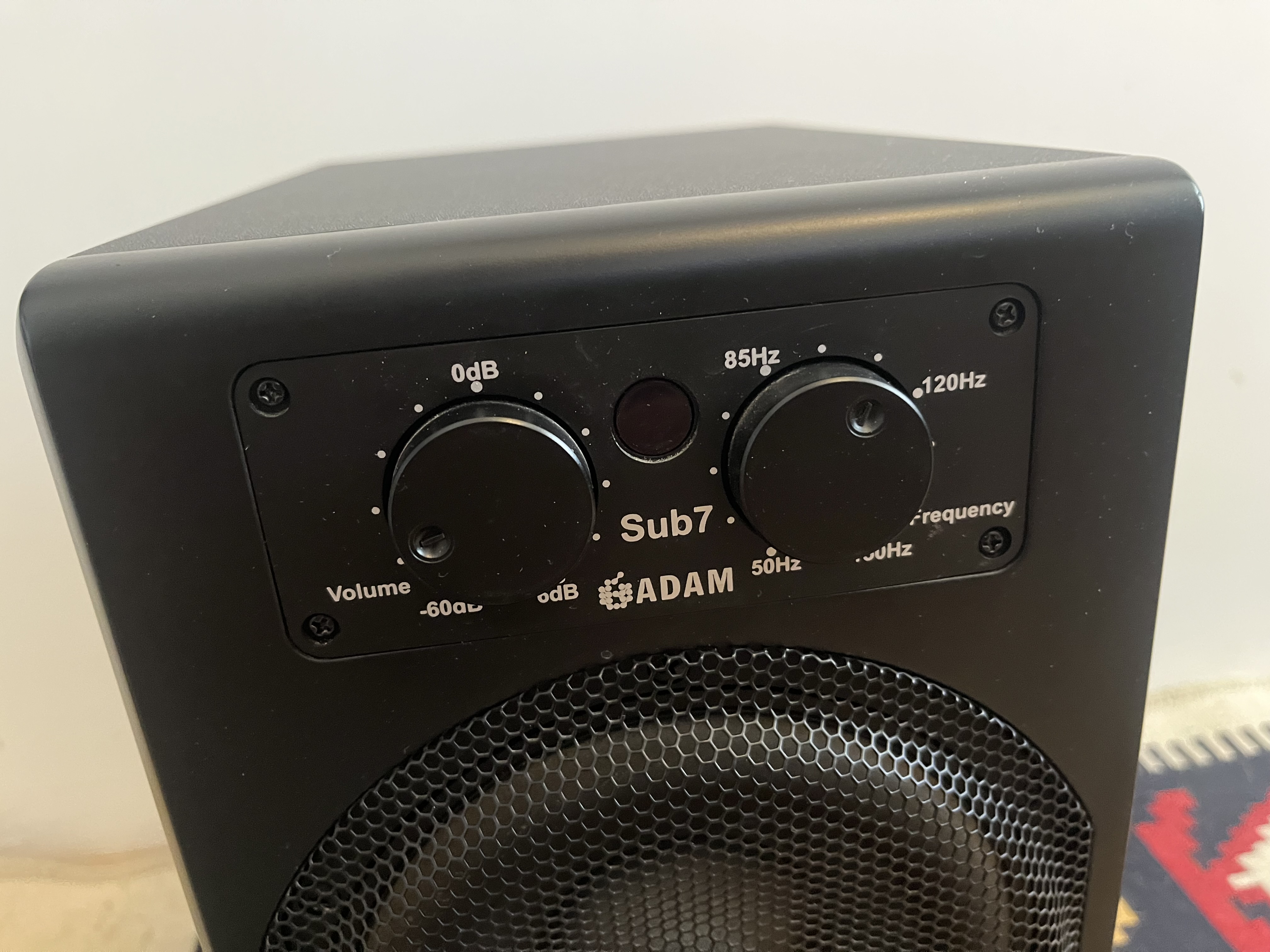 Close-up of ADAM Sub7 front-panel controls for volume and crossover frequency.